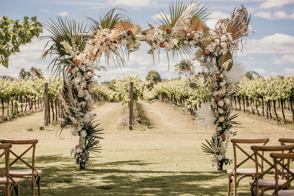 Fresh and preserved flowers on the amazing wedding arbour boho design bu Mudgee Monkey wedding florist and stylist in Mudgee at the vinegrove mudgee wedding venue 